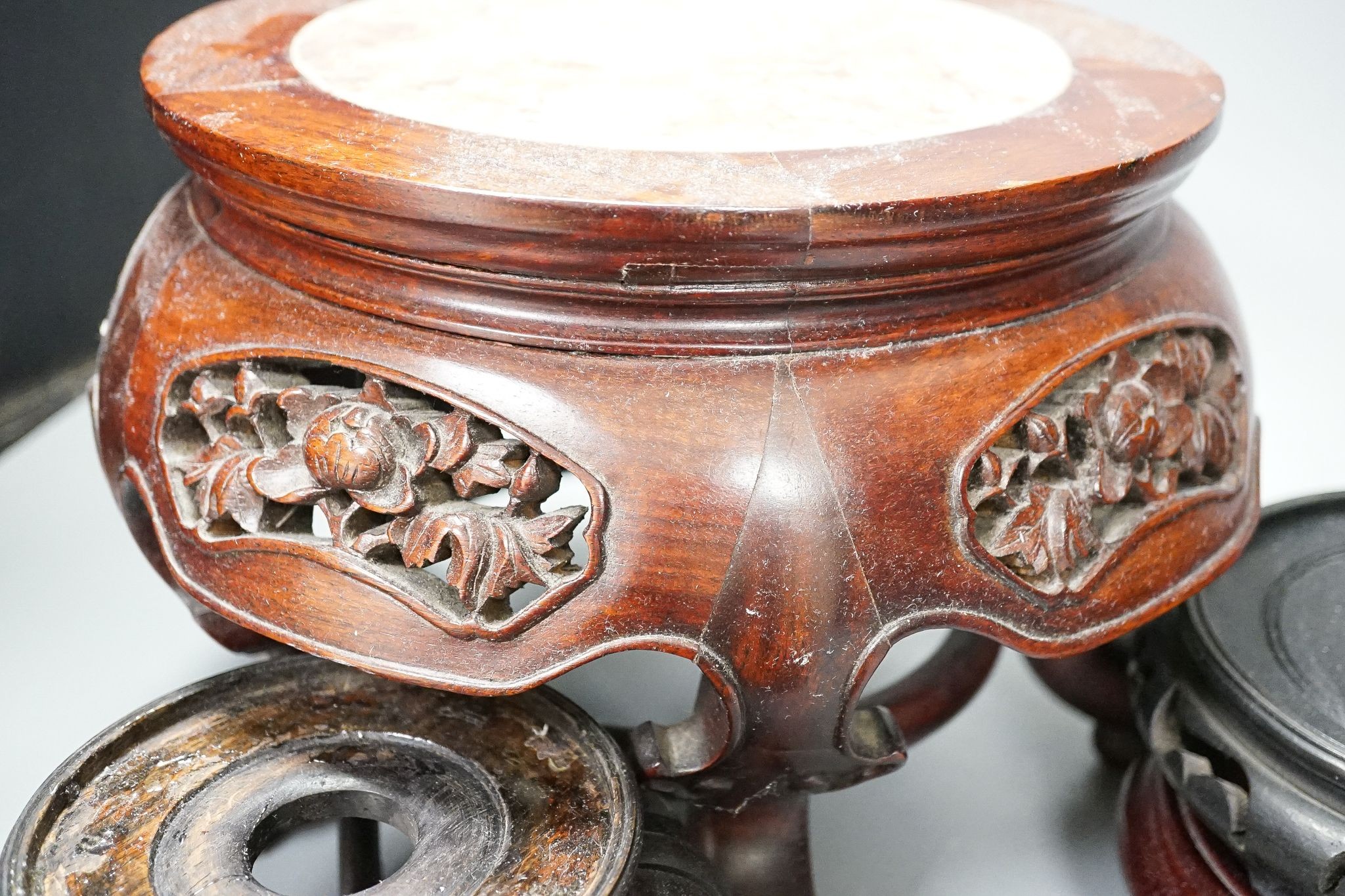 A group of Chinese hardwood stands, 19th/20th century, one marble inset, latter 19cm high